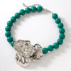 Turquoise beaded bracelet with silver floral clasp on a white background
