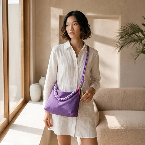 Woman holding a purple handbag indoors