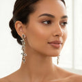 Woman wearing elegant earrings with a neutral background