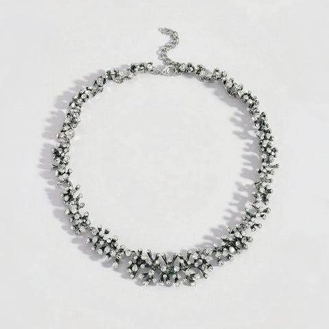 Silver necklace with black stones on a white background
