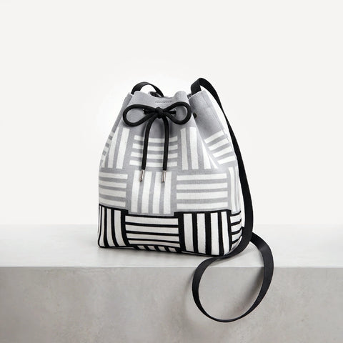 Drawstring bag with geometric pattern on a light gray background