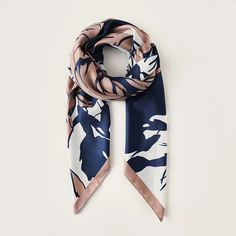 Navy and pink patterned scarf on a white background