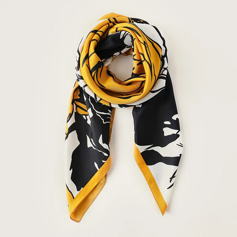 Scarf with black, white, and yellow pattern on a light gray background
