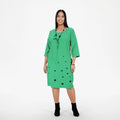 Green dress worn by a person on a white background