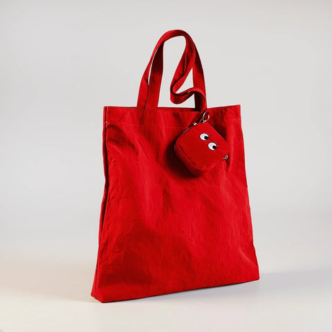 Red tote bag with a matching pouch on a light gray background