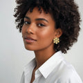 Woman wearing a white shirt with a neutral background