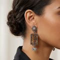 Close-up of a woman wearing an ornate earring with a blurred background