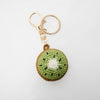 Crocheted kiwi keychain on a white background
