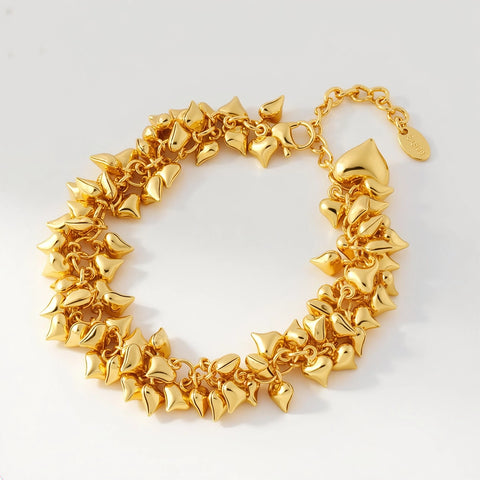 Gold  heart-shaped bracelet on a light gray background
