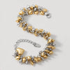 Gold and silver  heart-shaped bracelet on a light gray background
