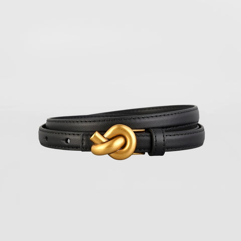 Black leather bracelet with a gold knot clasp on a light gray background