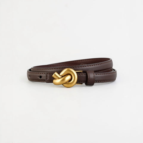 Brown leather belt with a gold knot buckle on a light gray background