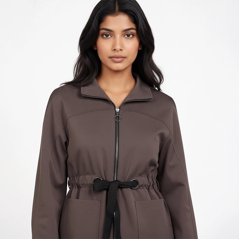 Woman wearing a brown coat with a white background