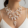 Pearl necklace with gold accents on a model wearing a white top.