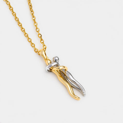 Gold and silver necklace with a unique pendant on a white background