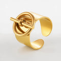 Gold cuff bracelet on a light gray background