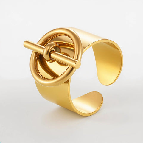 Gold cuff bracelet on a light gray background