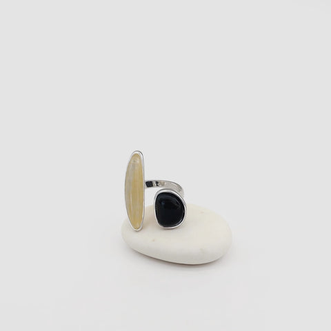 Silver ring with a black stone on a white background