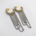 A pair of gold and silver statement dangle earrings on a clean white background. Each earring features a textured gold hoop with multiple layered silver curb chain dangles.