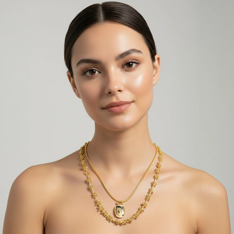 Woman wearing a gold necklace on a gray background