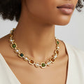 Necklace with gold chain and multicolored beads worn by a person