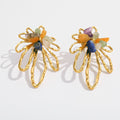 A pair of gold flower-shaped earrings with small multicolored gemstone accents, displayed on a clean white background.