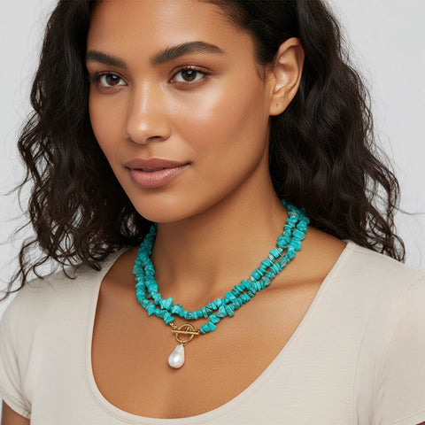 Woman wearing a turquoise necklace with a white background