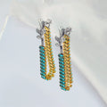Pair of earrings with rose designs and gemstone accents on a white background