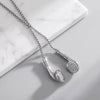 Silver slider necklaces with earbud-shaped pendant embellished with small clear stones, displayed on a light gray surface.