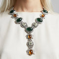 Necklace with gemstones on a mannequin against a neutral background